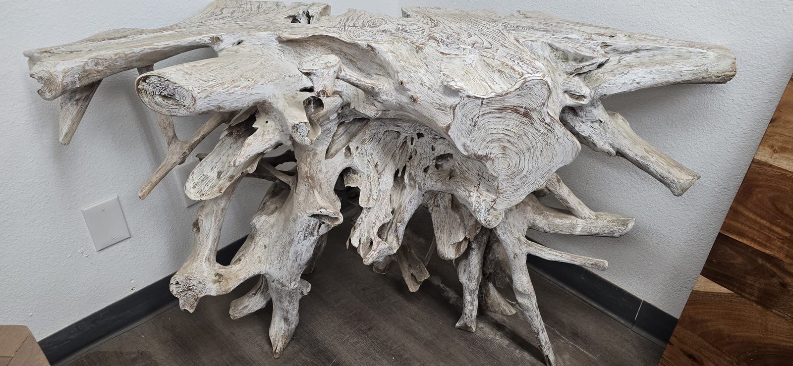 Teak root console table with carved wood form and natural texture